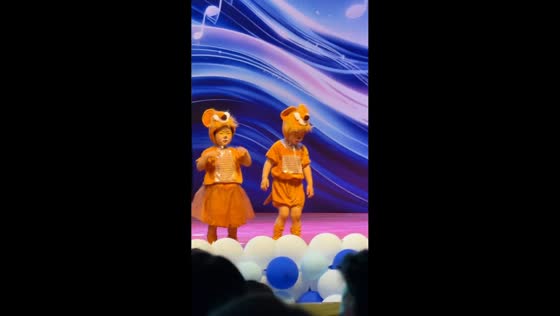 Sleepy child struggles to stay awake during stage performance in Hubei, China