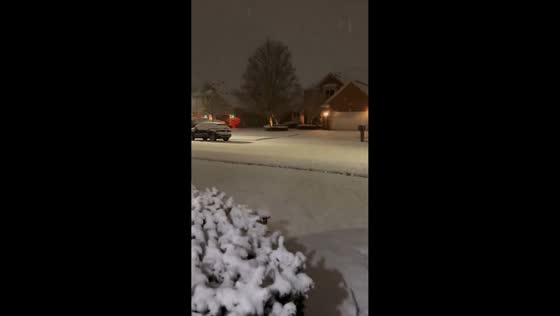 Steady snowfall blankets neighborhood in Michigan, USA