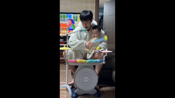 Father and child play drums and sing together in Jeonju-si, South Korea