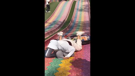 Lady falls on child while sliding at park in Henan province, China