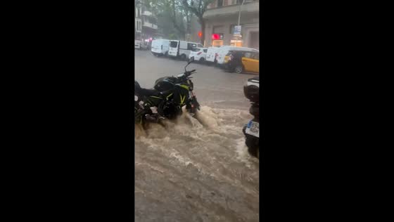 Muddy floodwaters inundate streets and vehicles after torrential rain in Barcelona, Spain