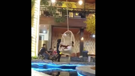 Kids spin wildly on bamboo swing at café in Lembang, Indonesia