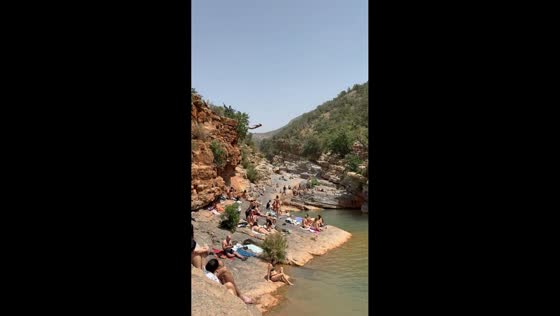 Cliff diver jumps into natural pools at Paradise Valley in Agadir, Morocco
