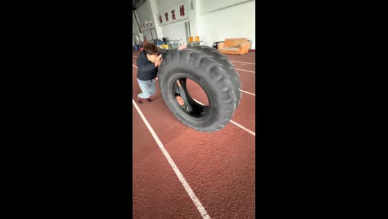 Boy spins inside truck tire in Shandong, China