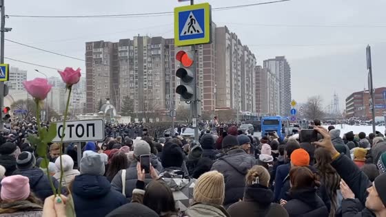 People chant "Navalny" and see off the hearse during the funeral procession