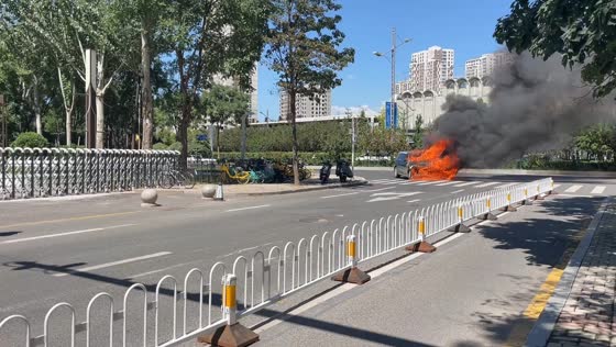 Firefighters battle intense car fire on road in Shanxi, China