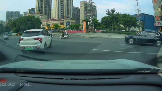 Motorcycle rider falls after colliding with car at roundabout in Guangxi, China