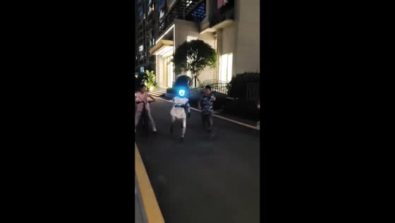 Children playfully run alongside robot companion in Sichuan, China