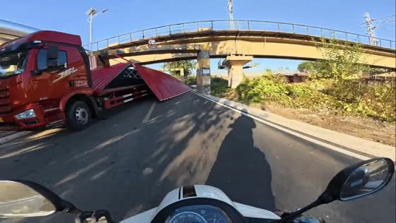 Oversized truck gets wedged under bridge in Tianjin, China