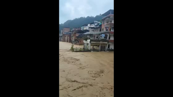 Muddy floodwaters inundate streets and buildings in Fankuai, China