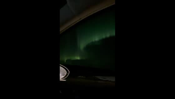 Vibrant aurora curtains illuminate the night sky in Keflavik, Iceland