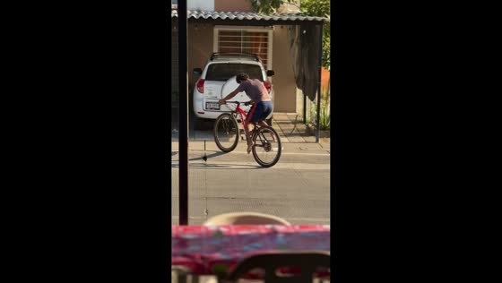 Teen rides bicycle without pedals in Manzanillo, Mexico