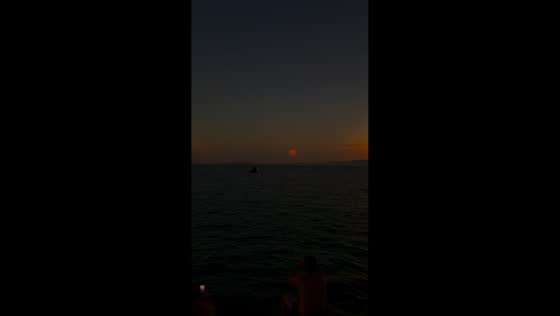 Ring-shaped solar eclipse glows over sea at sunset in Palma de Mallorca, Spain