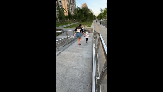 Mother and toddler fall while walking down ramp in Beijing, China