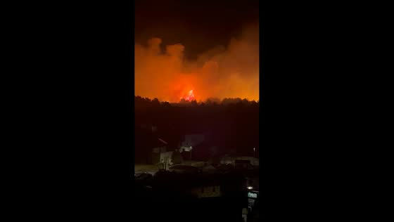 Massive wildfire glows behind residential area in Milna, Brač, Croatia