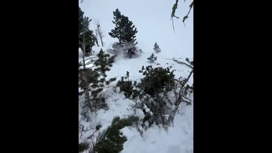Sled slips away during retrieval on a steep snowy hill in West Yellowstone, Montana, USA
