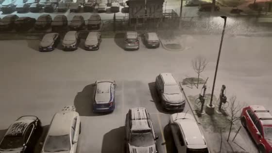 Snowfall covers parking lot in Buffalo, New York, USA