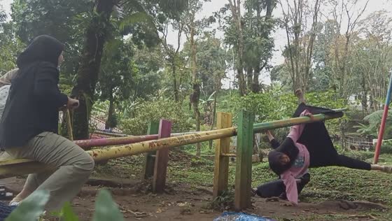 People fall off balance swings in Kajen, Indonesia