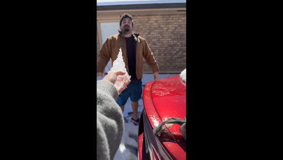 Friends play with an icicle from the roof in Louisiana, USA
