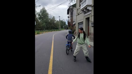Kids collide as one rides a bike and the other skates backward in Quito