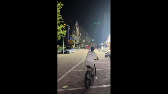 Woman on bicycle pulled by drone in Shandong, China