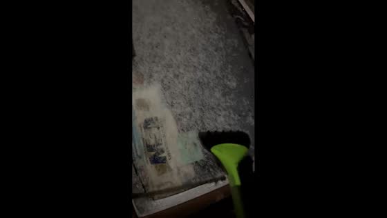 Frozen windshield scraped on chilly winter morning in Gray, Kentucky, USA