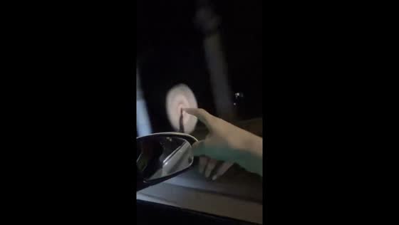 Woman spins game cards in the wind during car ride in Guangxi, China