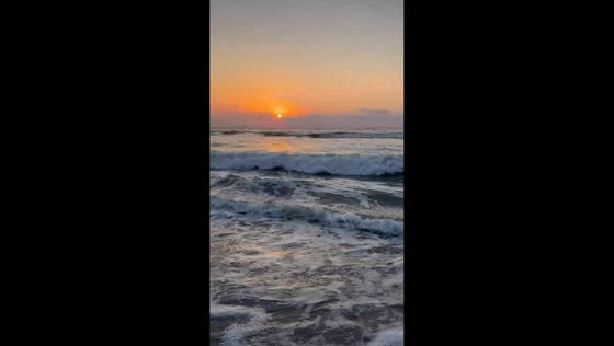 Golden sunrise illuminates the shoreline in Surfside Beach, South Carolina, USA