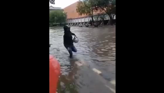 The guy fell into the water during the flood after a heavy downpour!