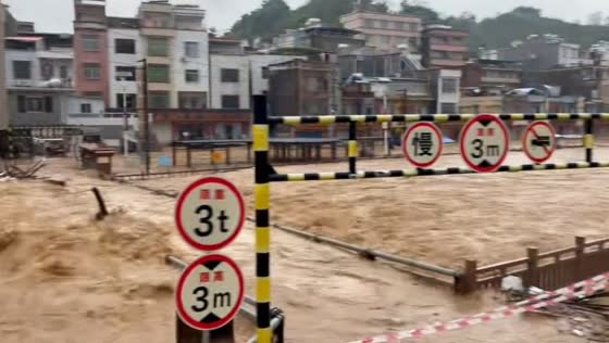 Bridge submerged as severe flooding inundates Shuangjiao Town in Guangdong, China