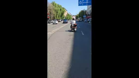 Scooter drifts sideways on city road in Jilin, China
