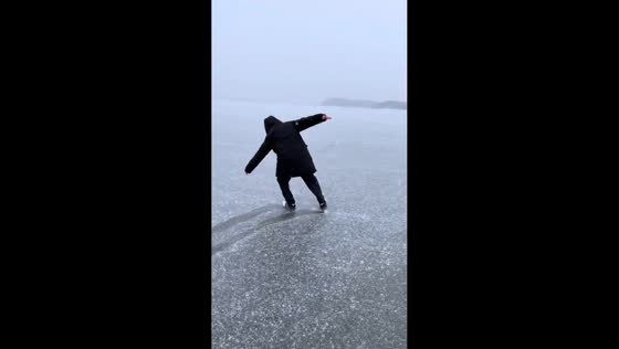 Man slips and falls on frozen lake in Heilongjiang, China