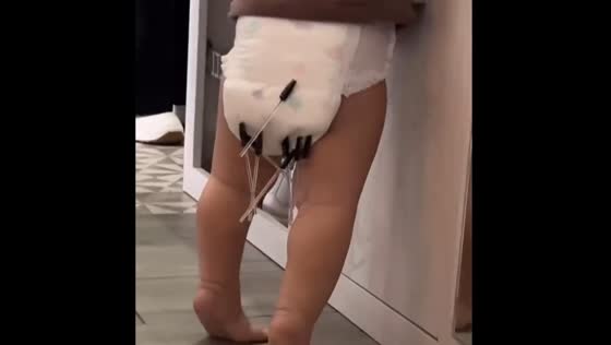 Child crawling with eyelash brushes stuck to diaper in Perm, Russia