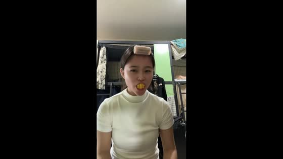 Woman mimics brushing teeth with mango slice in Sichuan, China