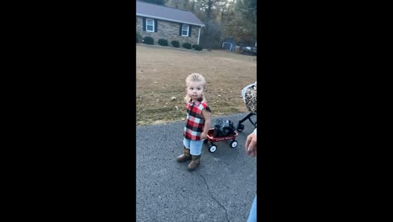 Kid dressed as Joe Dirt walks with cart on Halloween in Bremen, Kentucky