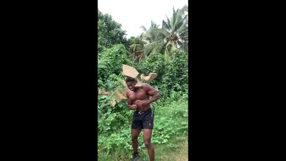 Man demonstrates strength by breaking block on head in Ikorodu, Lagos, Nigeria