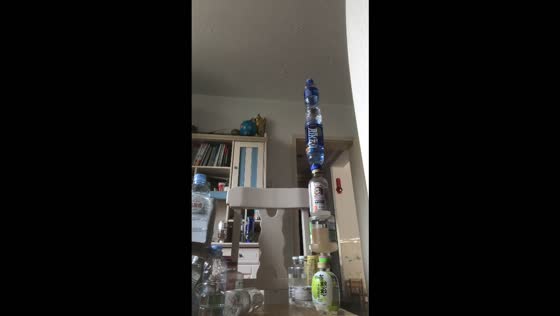Bottle-flipping challenge creates an impressive five-bottle tower in Tianjin, China