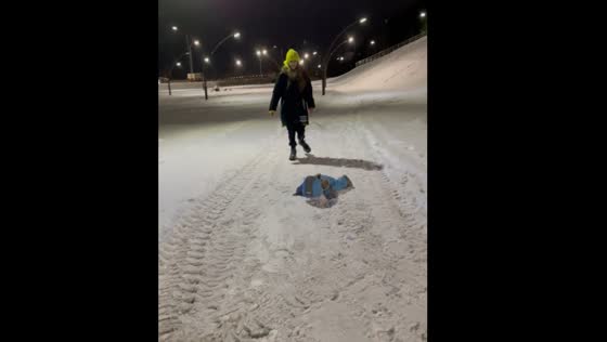 Monkey in baby clothes falls while walking on snow in Russia