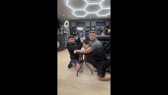 Arm wrestling match ends in injury during workplace moment in Manchester, England, UK