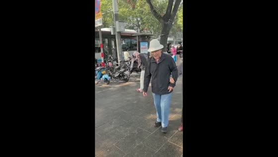 Person struggles to walk as shoes stick to pavement in Beijing, China
