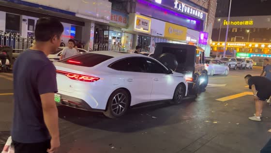 Cars stuck together fail to separate as bystanders watch in Gansu, China