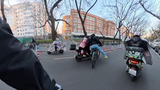 Minor bicycle and e-bike collision on busy highway in Beijing, China