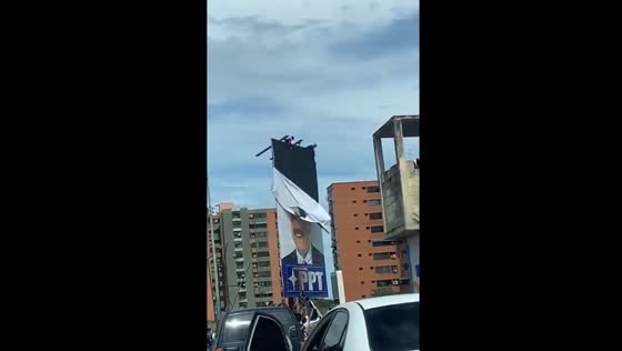 People remove Nicolás Maduro billboard amid election dispute in Venezuela