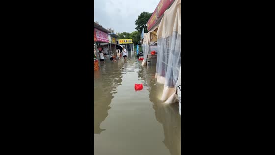 Severely flooded area with stalls submerged in murky water in Jiangsu, China