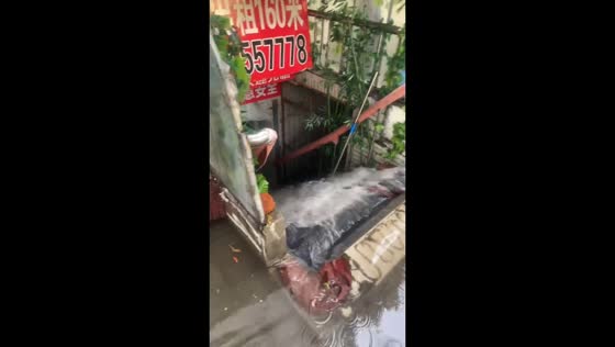 Large volume of floodwater cascades down basement staircase in Liaoning, China