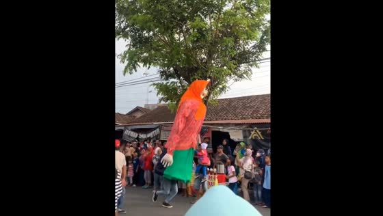 Ondel-ondel performer accidentally bumps into woman during carnival in Jatinom, Indonesia
