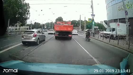 KAMAZ truck hits scooter rider during a U-turn in Kaliningrad, Russia