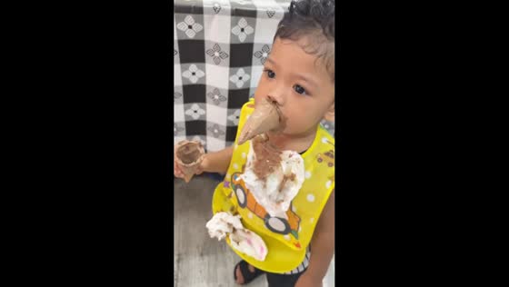 Child hilariously eats chocolate ice cream in Melaka, Malaysia