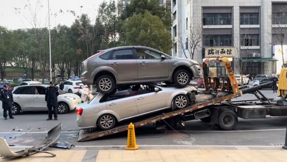 Stacked vehicles loaded onto tow truck after crash in Zhejiang, China