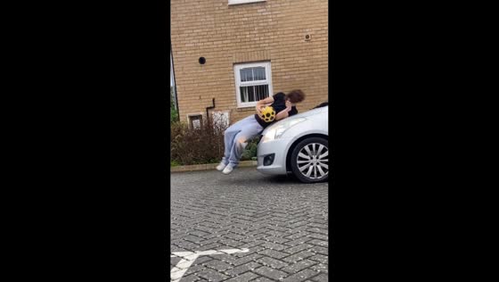 Unexpected road bump while man retrieves football in Bushey, UK
